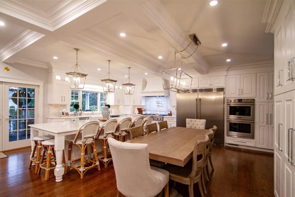 open concept kitchen with white cabinets and island bar