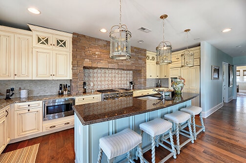 Light blue island cabinet in an off-white kitchen