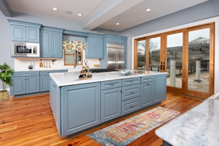 Light blue kitchen cabinet with natural wood accents