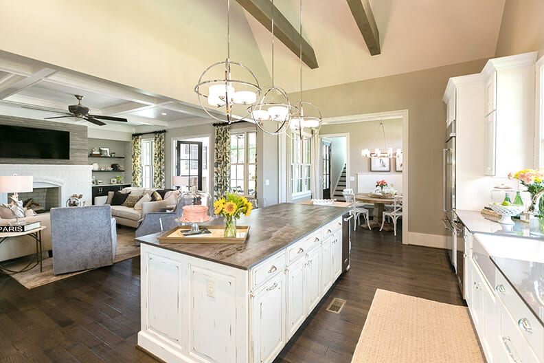 Large kitchen with antique white kitchen cabinets and a large white island